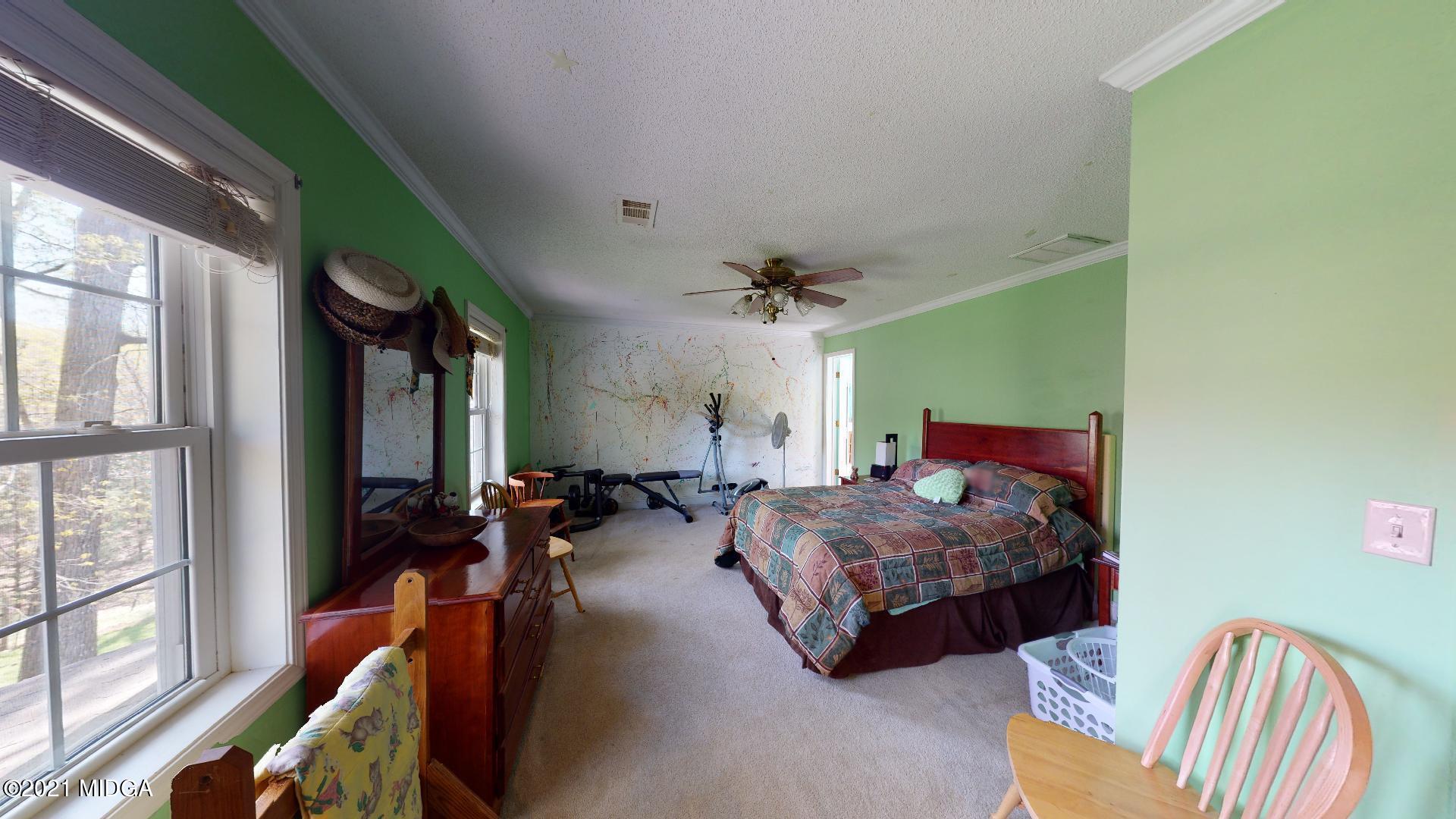 1534 Smith Road Forsyth, GA 31029 - Photo 15 of 25 a bedroom with bed and a large window