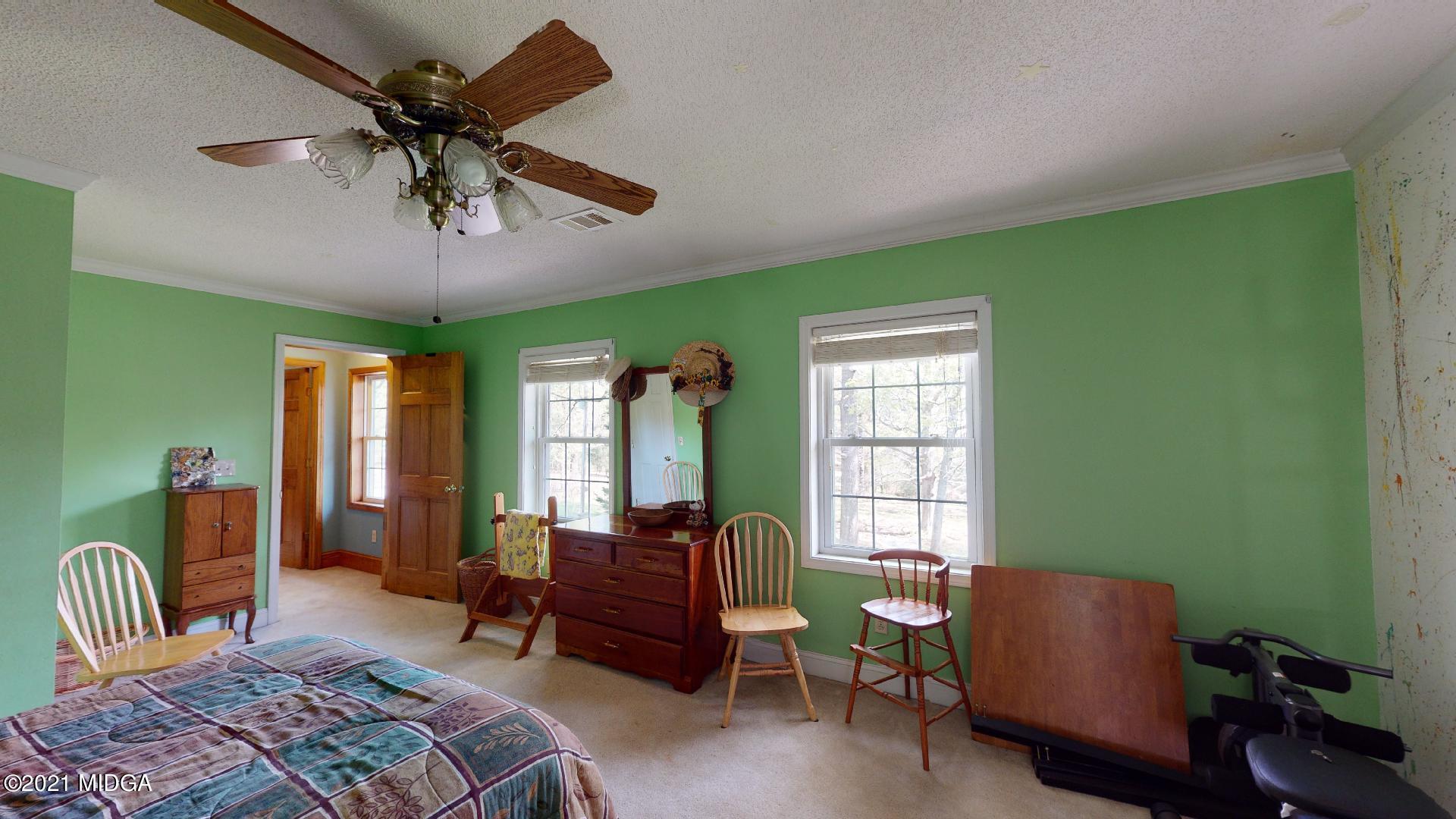 1534 Smith Road Forsyth, GA 31029 - Photo 16 of 25 a living room with furniture a ceiling fan and a window
