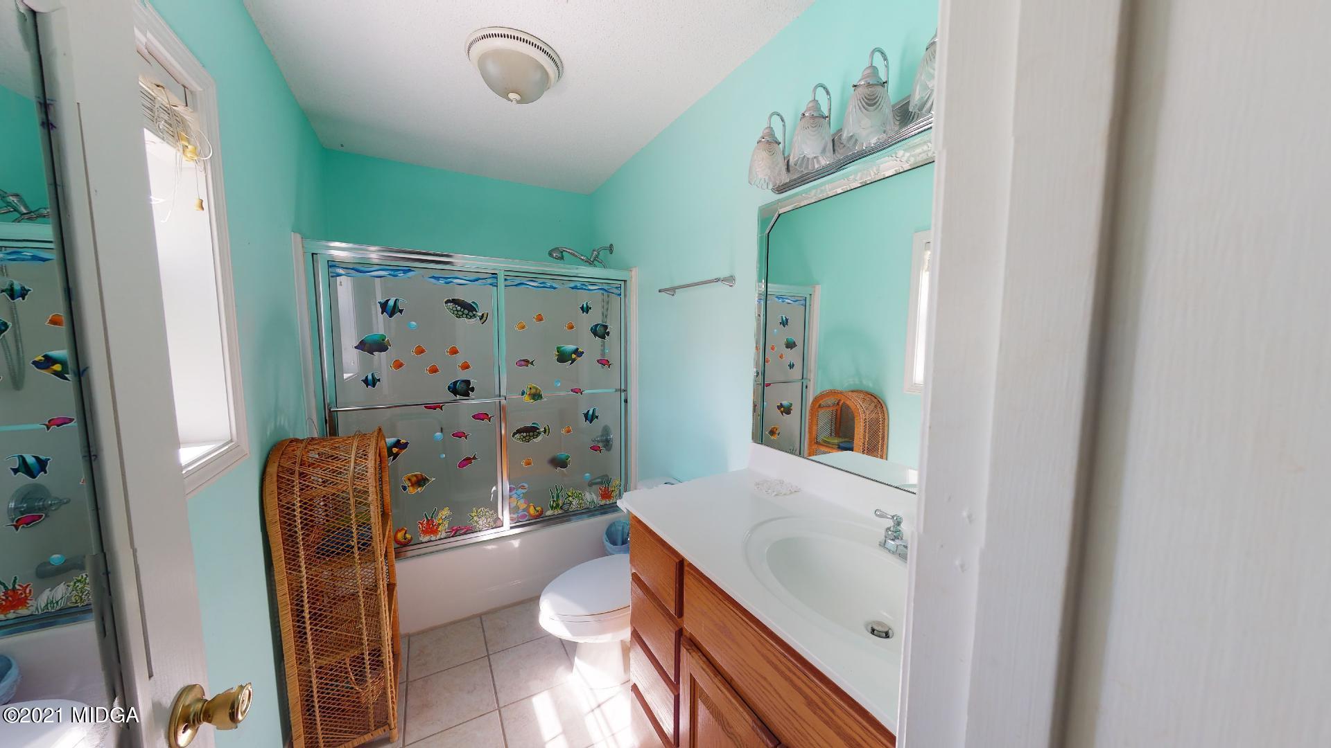 1534 Smith Road Forsyth, GA 31029 - Photo 17 of 25 a bathroom with a sink a toilet and shower