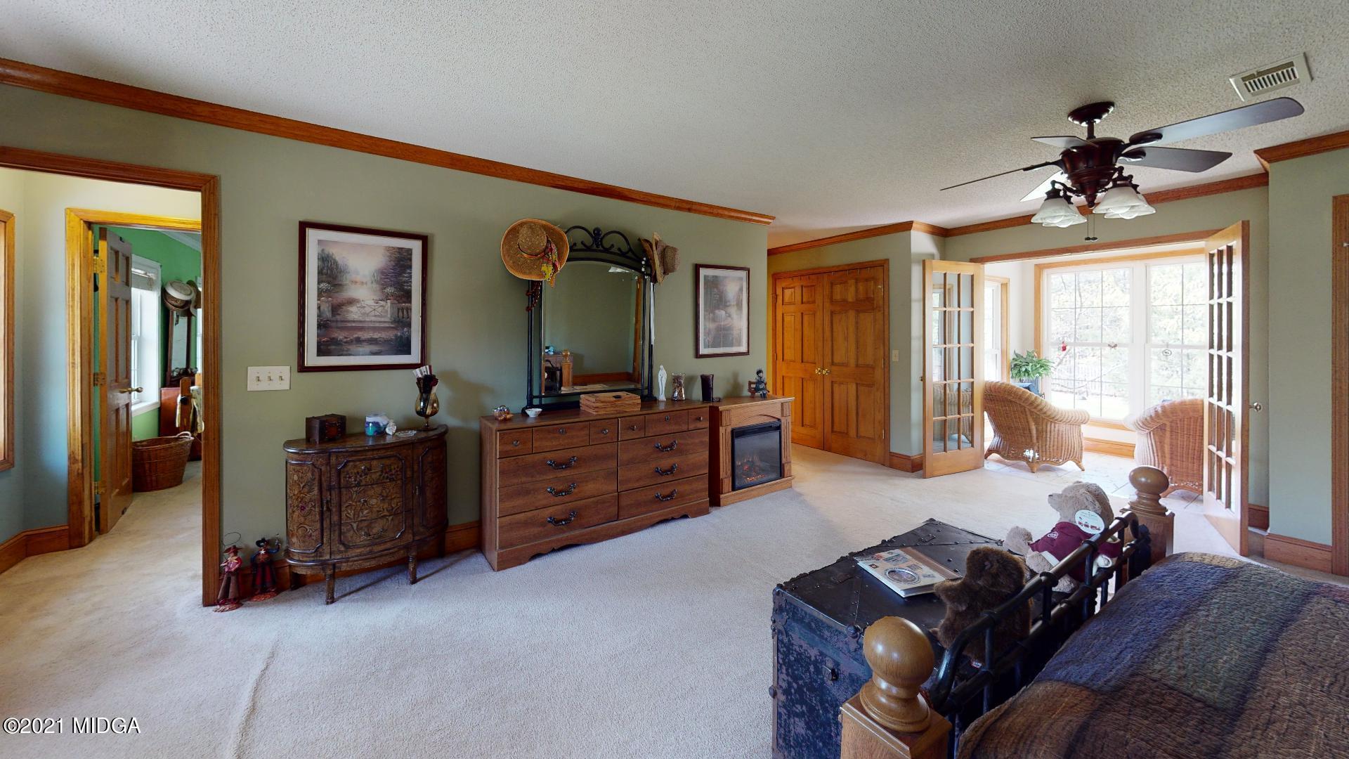 1534 Smith Road Forsyth, GA 31029 - Photo 19 of 25 a living room with furniture and a flat screen tv