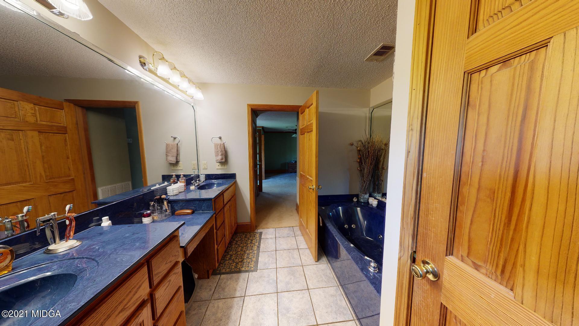 1534 Smith Road Forsyth, GA 31029 - Photo 20 of 25 a bathroom with a double vanity sink and a mirror