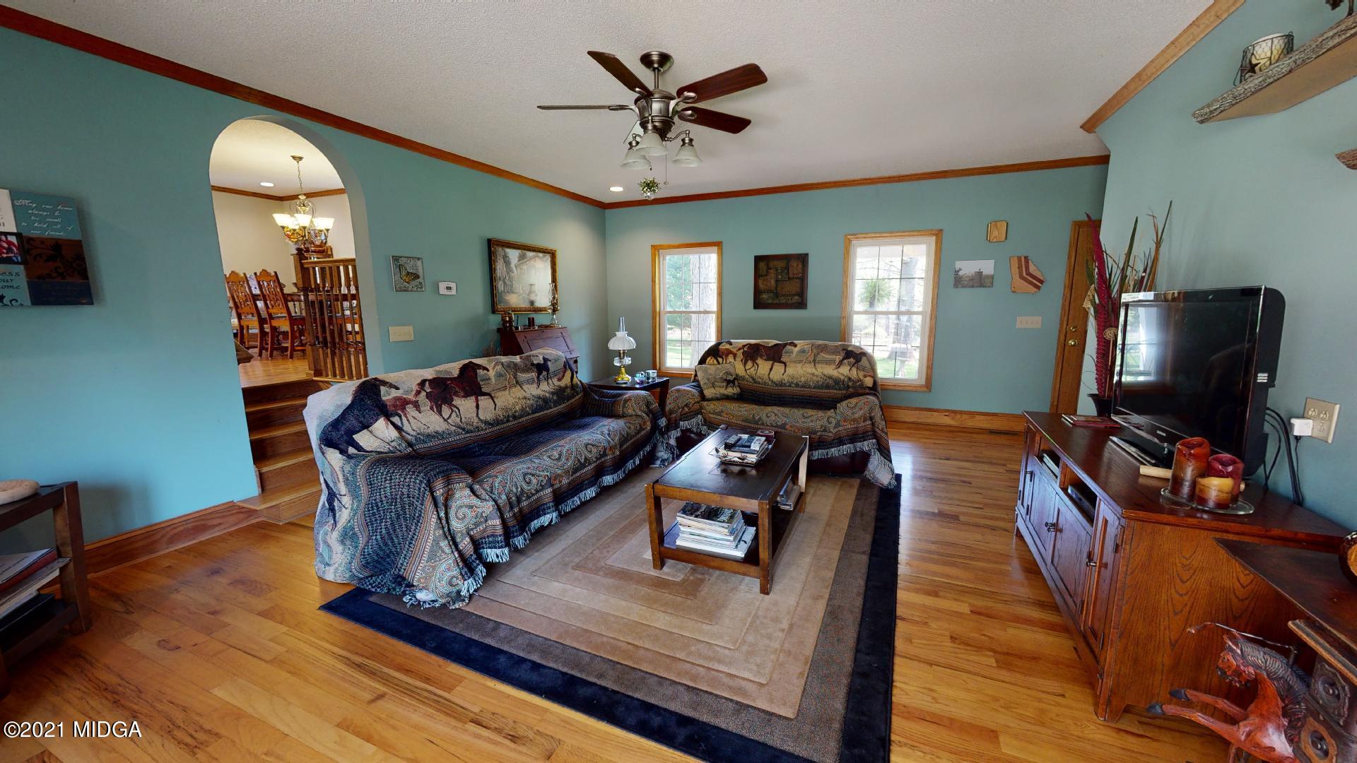 1534 Smith Road Forsyth, GA 31029 - Photo 3 of 25 a living room with furniture and a flat screen tv