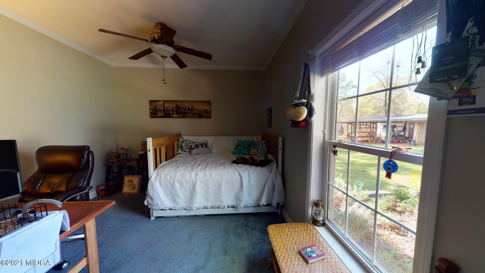 1534 Smith Road Forsyth, GA 31029 - Photo 10 of 25 a bedroom with a bed and a window