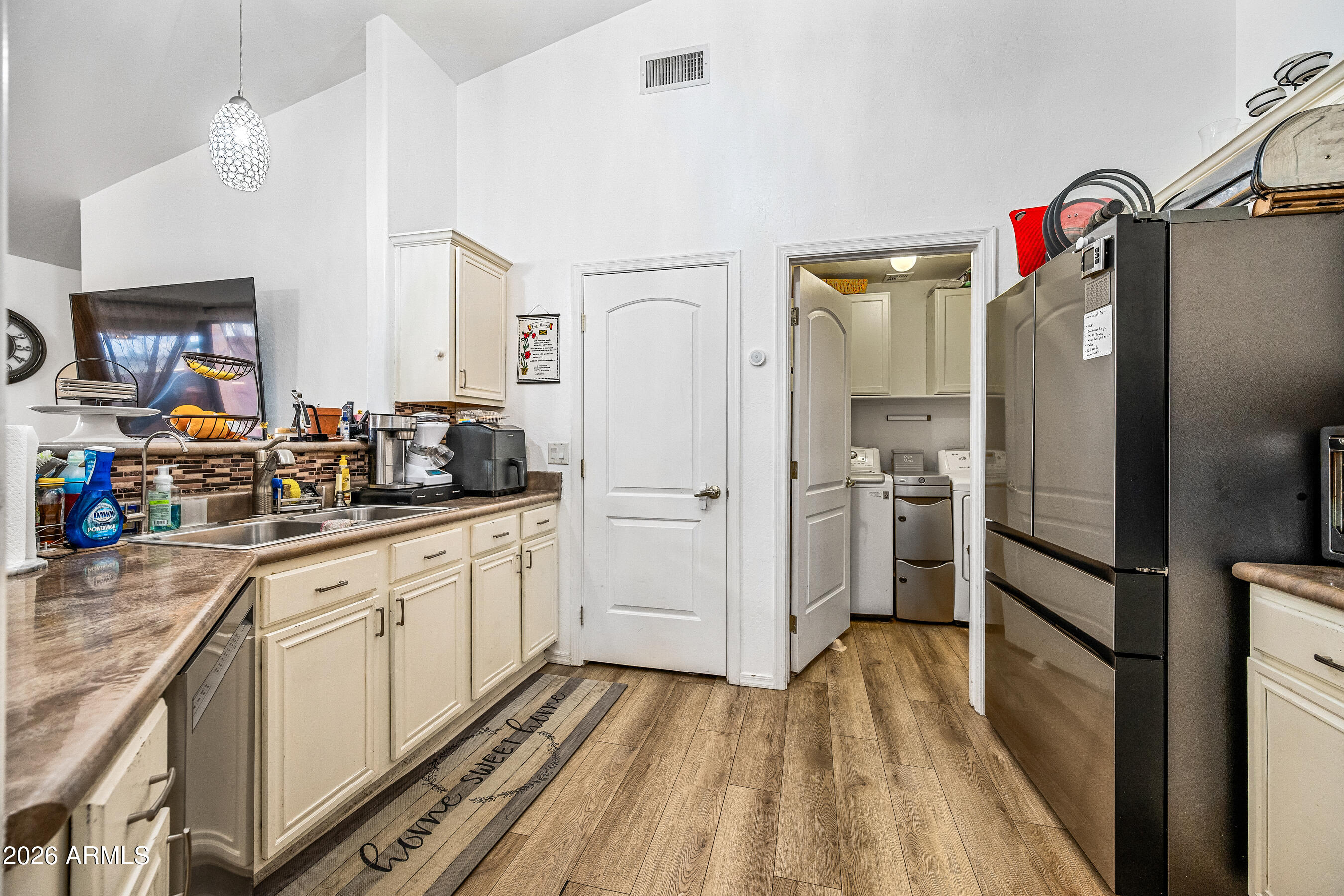 1260 South Lindsay Road, Unit 38 Mesa, AZ 85204 - Photo 8 of 23 a kitchen with white cabinets and refrigerator
