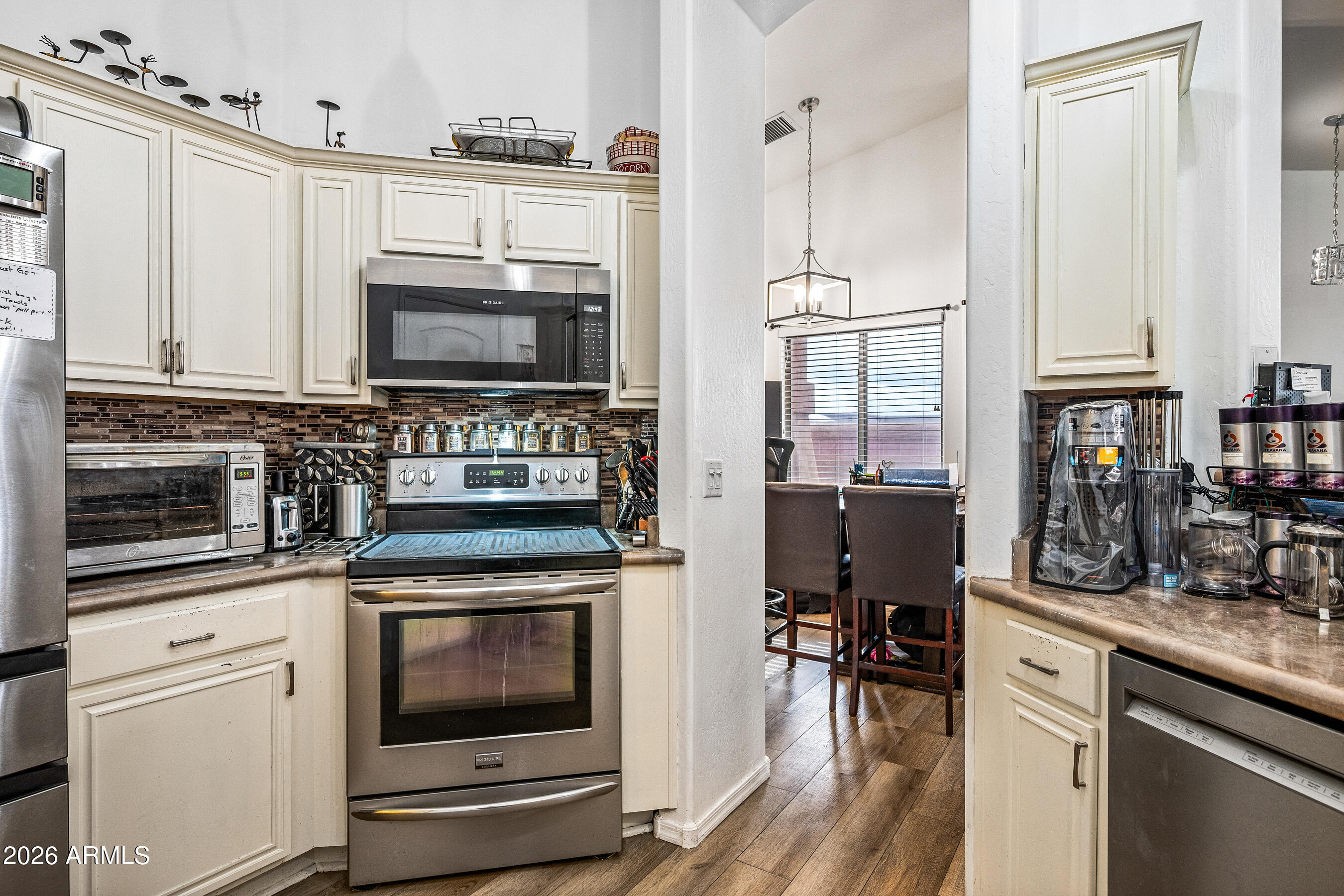 1260 South Lindsay Road, Unit 38 Mesa, AZ 85204 - Photo 10 of 23 a kitchen with stainless steel appliances granite countertop a stove a sink and a microwave