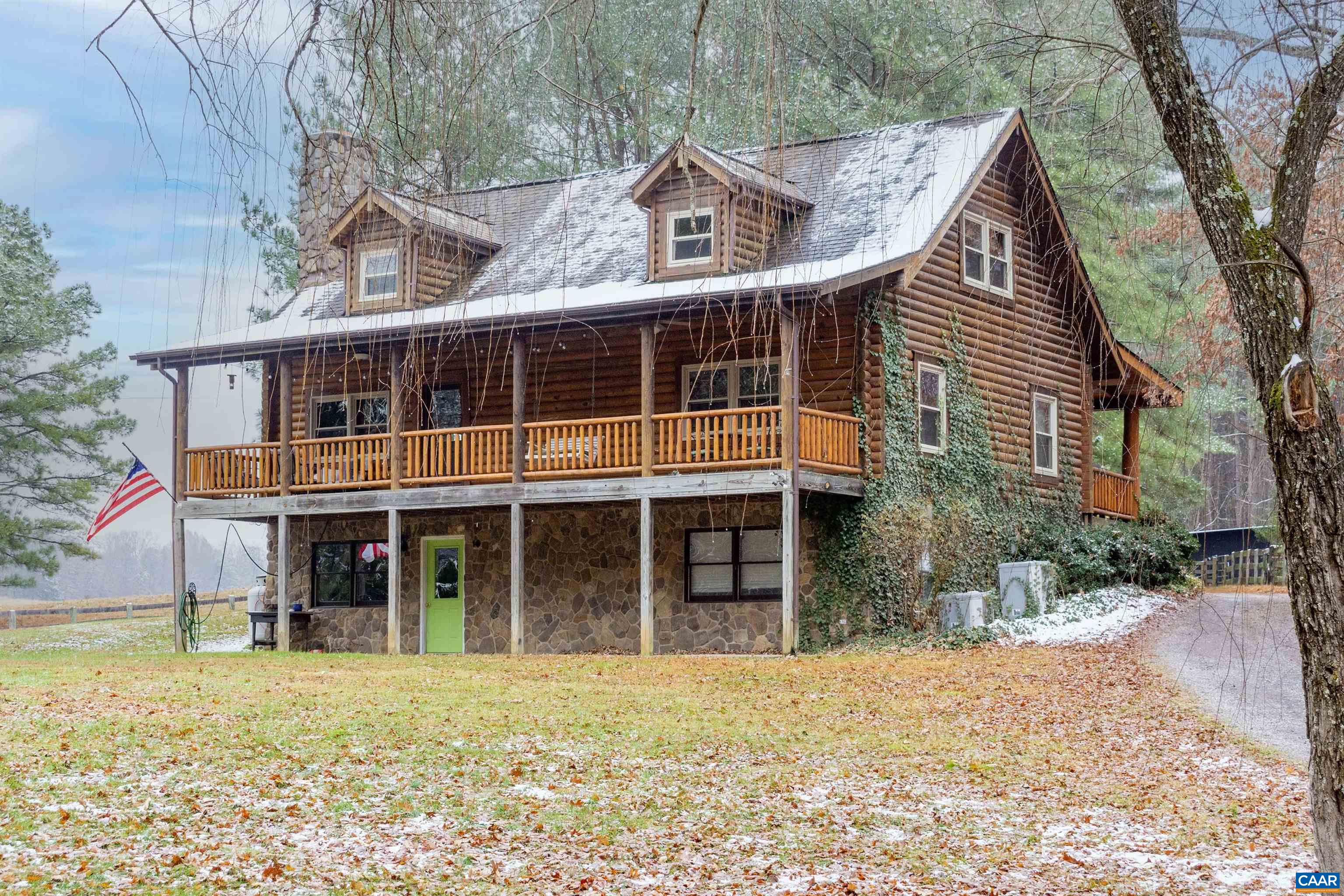 a view of a house with a yard and sitting area