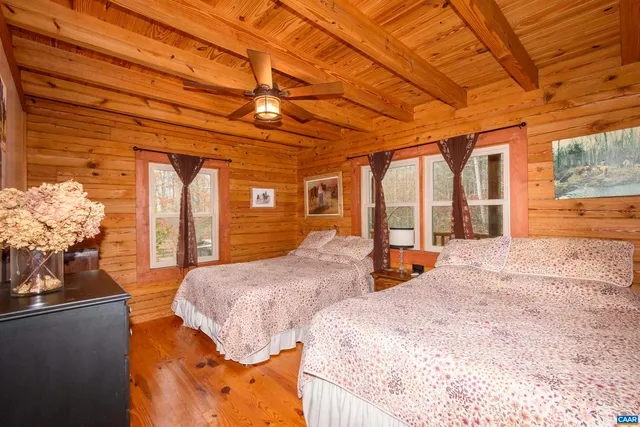 a bedroom with natural light and wooden floor