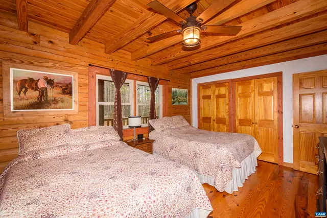 a bedroom with two beds and a chandelier