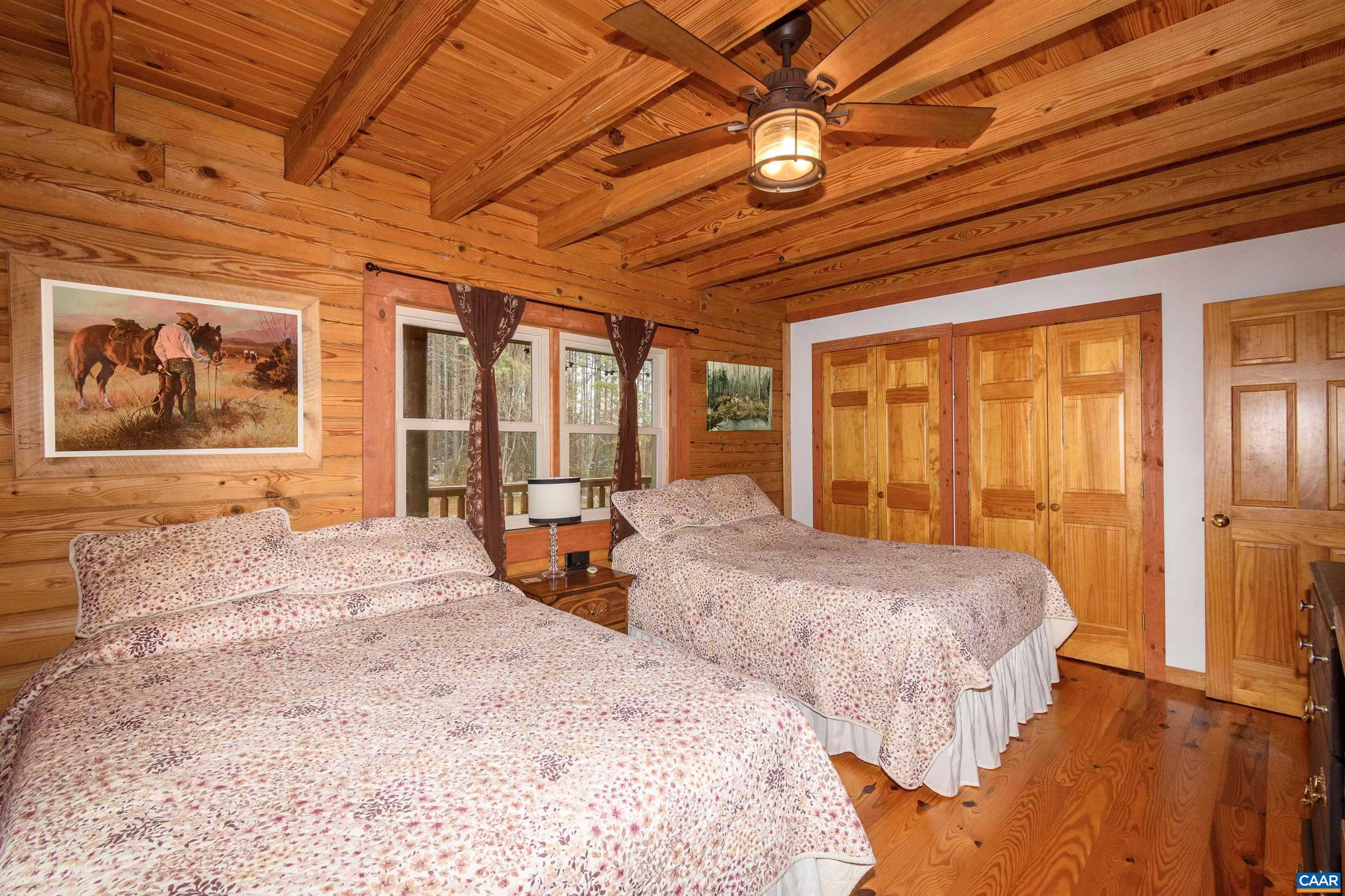 11441 Old Lawyers Road Unionville, VA 22567 - Photo 12 of 45 a bedroom with two beds and a chandelier