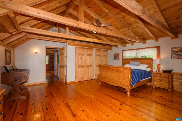 a bedroom with furniture and wooden floor