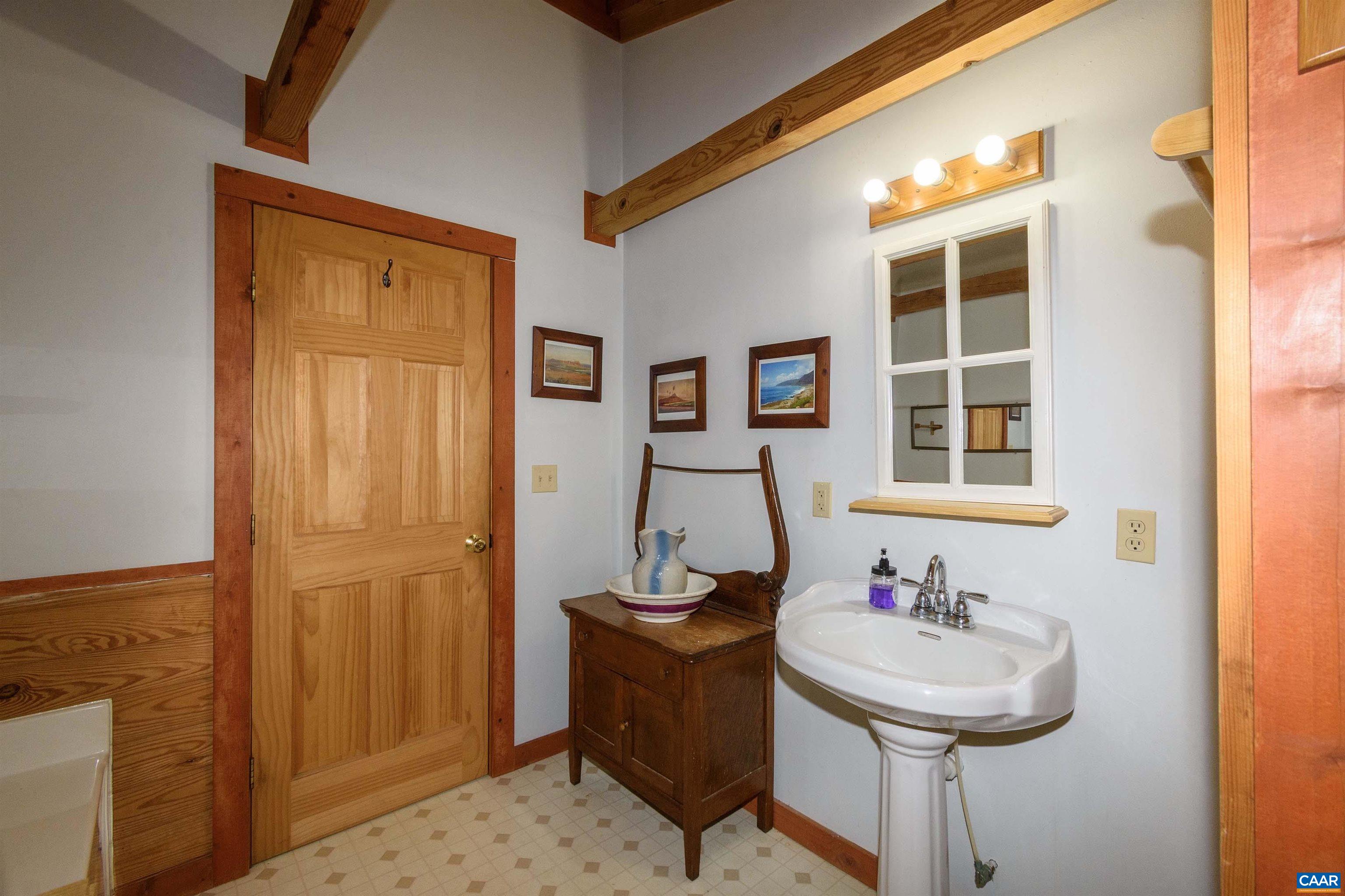 11441 Old Lawyers Road Unionville, VA 22567 - Photo 25 of 45 a bathroom with a sink and a mirror