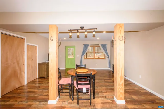 a view of a room with a wooden table and chairs