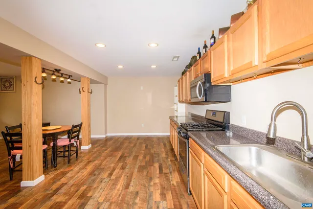 a kitchen with stainless steel appliances granite countertop a stove and a sink