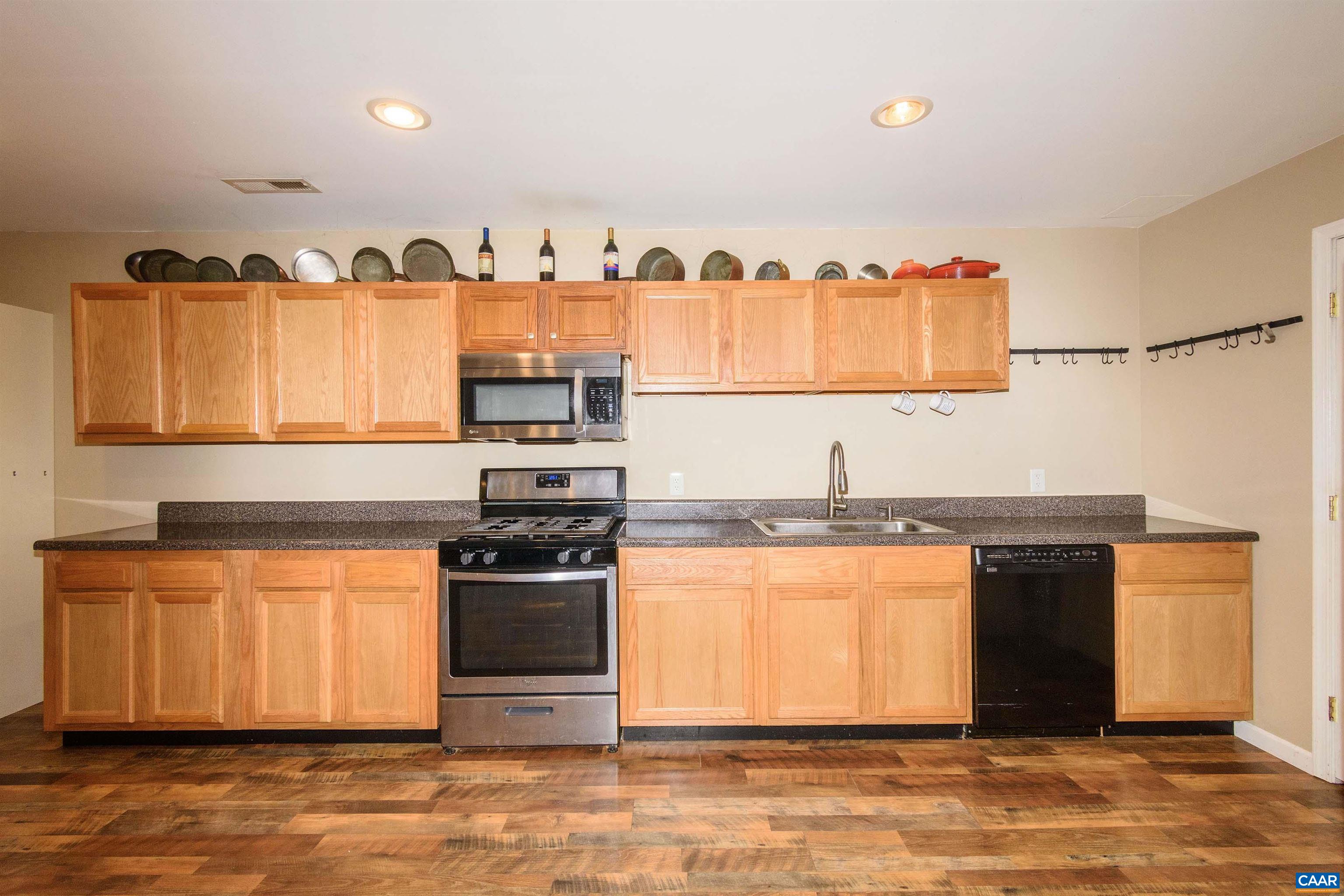 11441 Old Lawyers Road Unionville, VA 22567 - Photo 32 of 45 a kitchen with stainless steel appliances granite countertop a stove and a sink