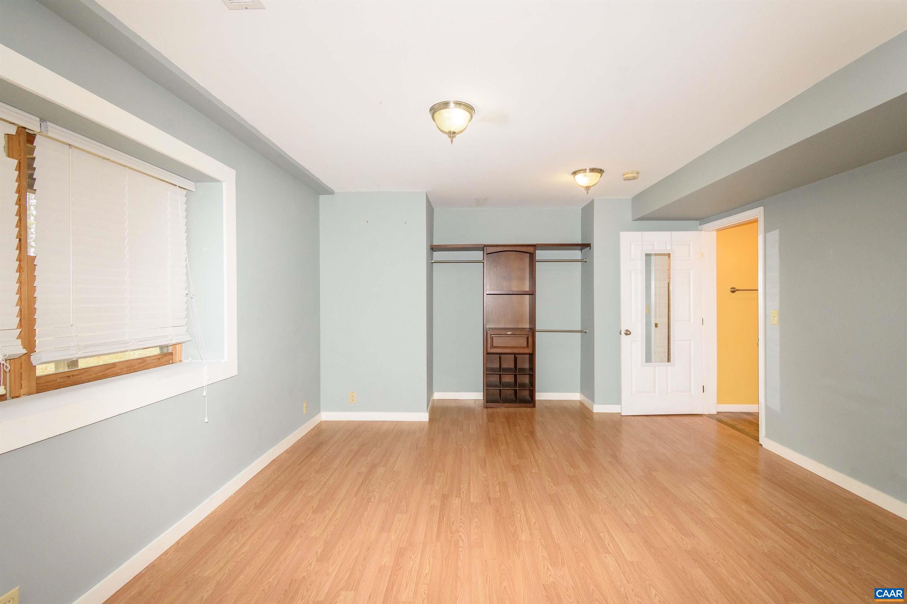 11441 Old Lawyers Road Unionville, VA 22567 - Photo 38 of 45 a view of an empty room with wooden floor and a window