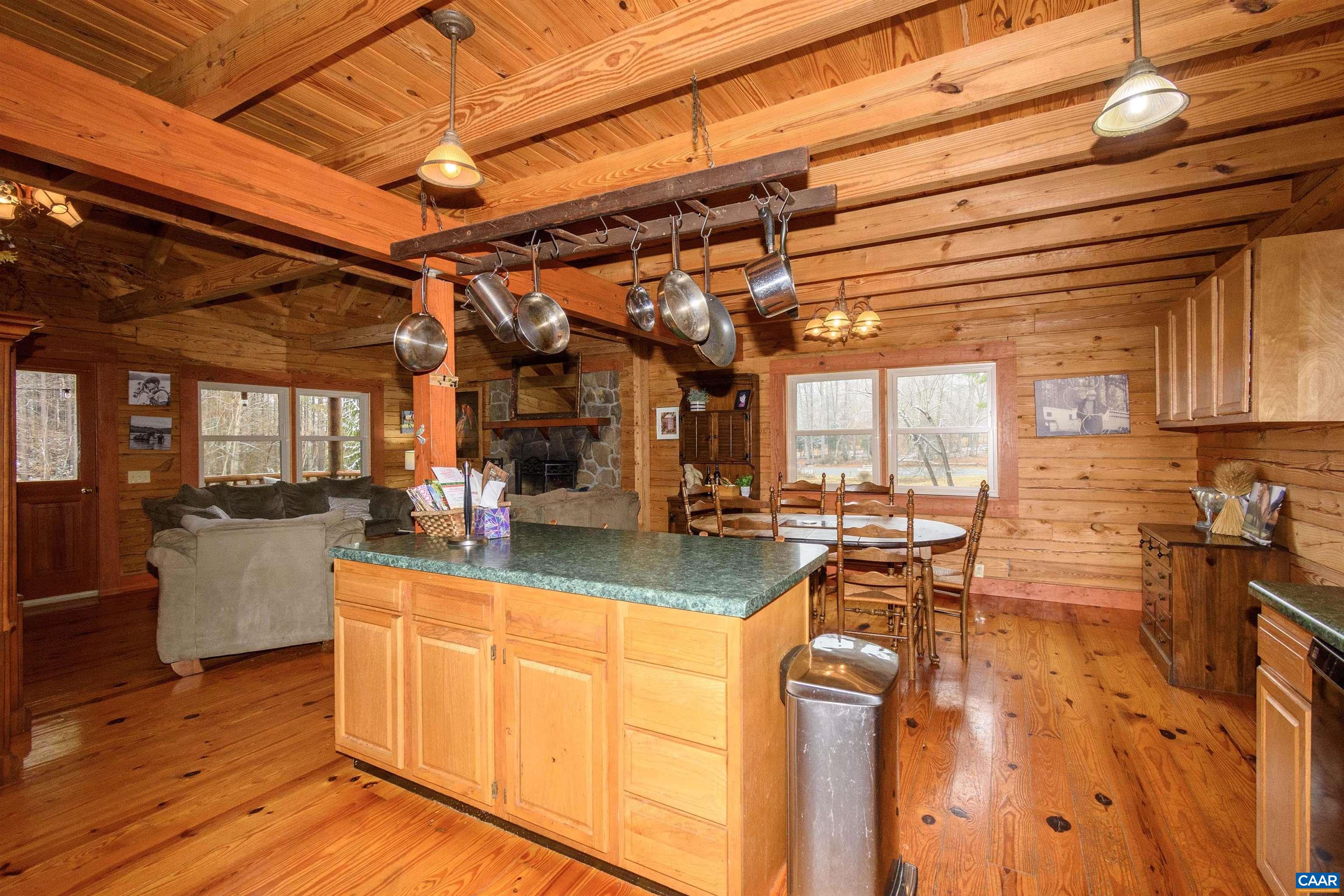 11441 Old Lawyers Road Unionville, VA 22567 - Photo 4 of 45 a view of a kitchen with kitchen island granite countertop a large counter top couches and stainless steel appliances