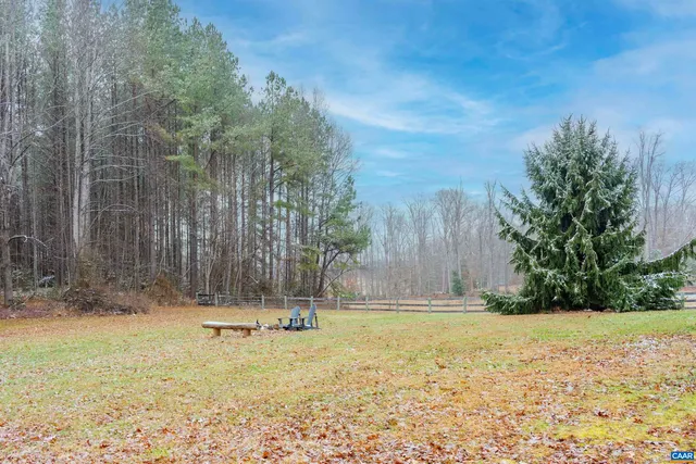 a view of a house with yard and sitting area