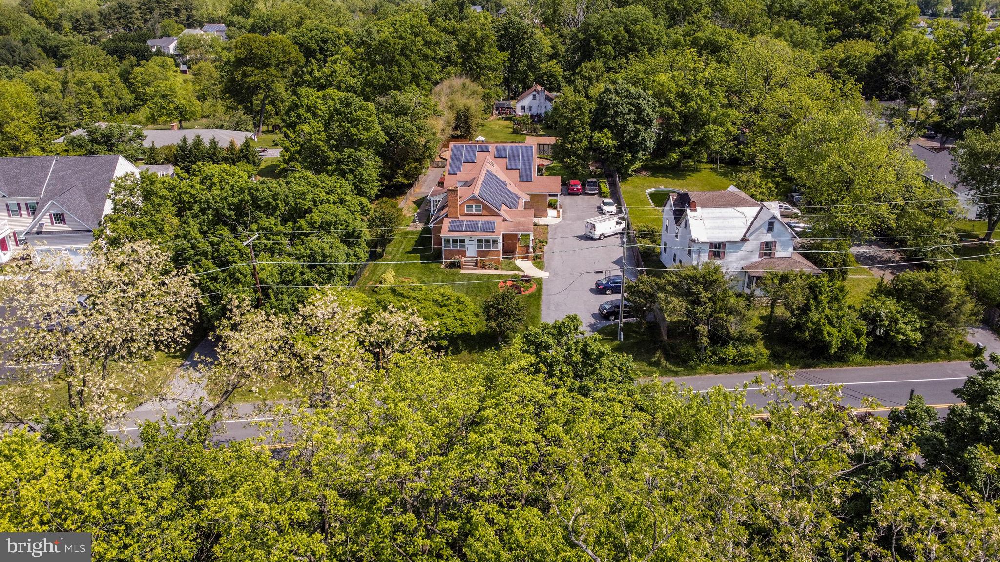 2816 Old Briggs Chaney Road Silver Spring, MD 20905 - Photo 3 of 93 an aerial view of a house with swimming pool and garden