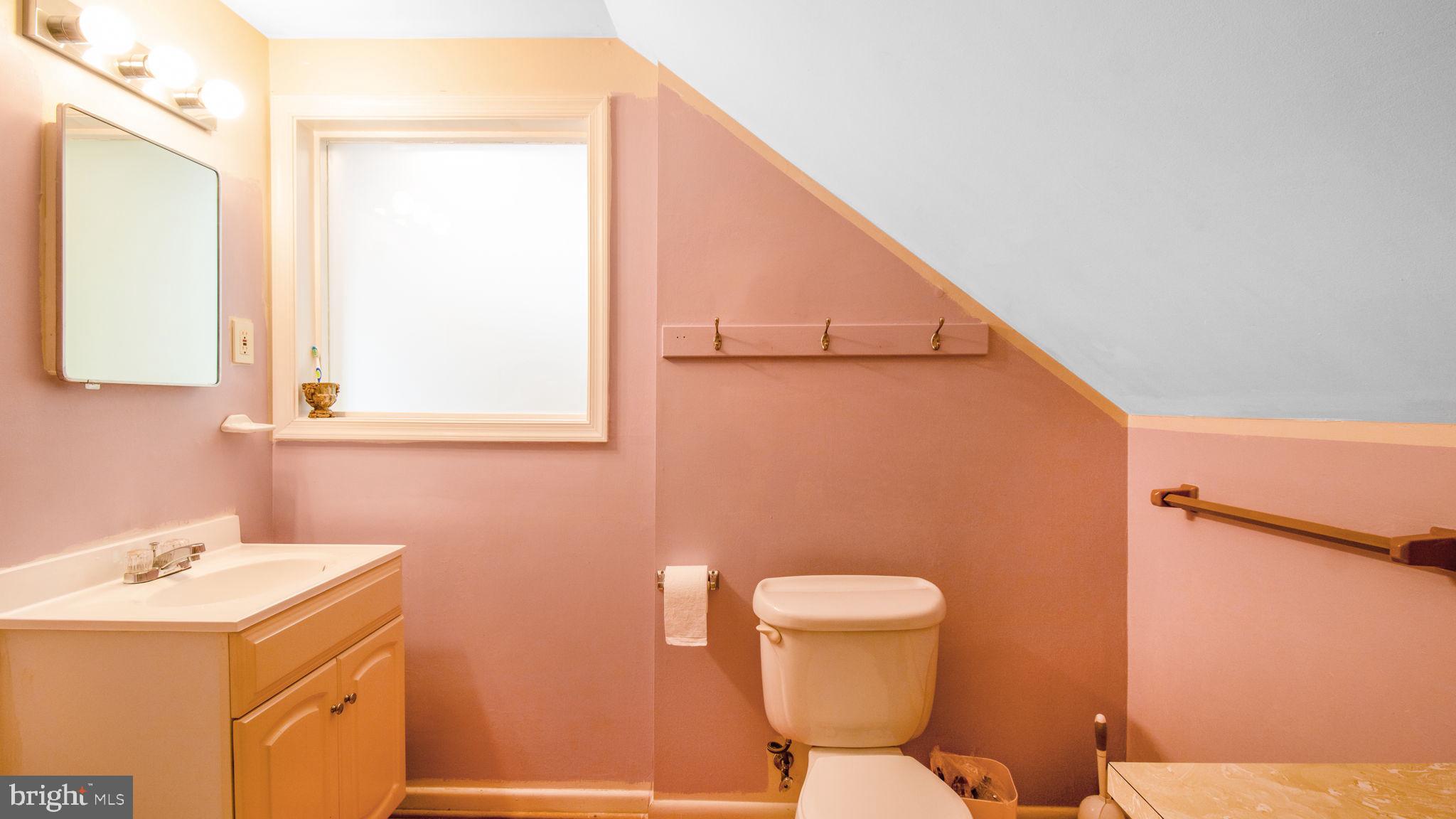 2816 Old Briggs Chaney Road Silver Spring, MD 20905 - Photo 71 of 93 a bathroom with a sink a toilet and mirror