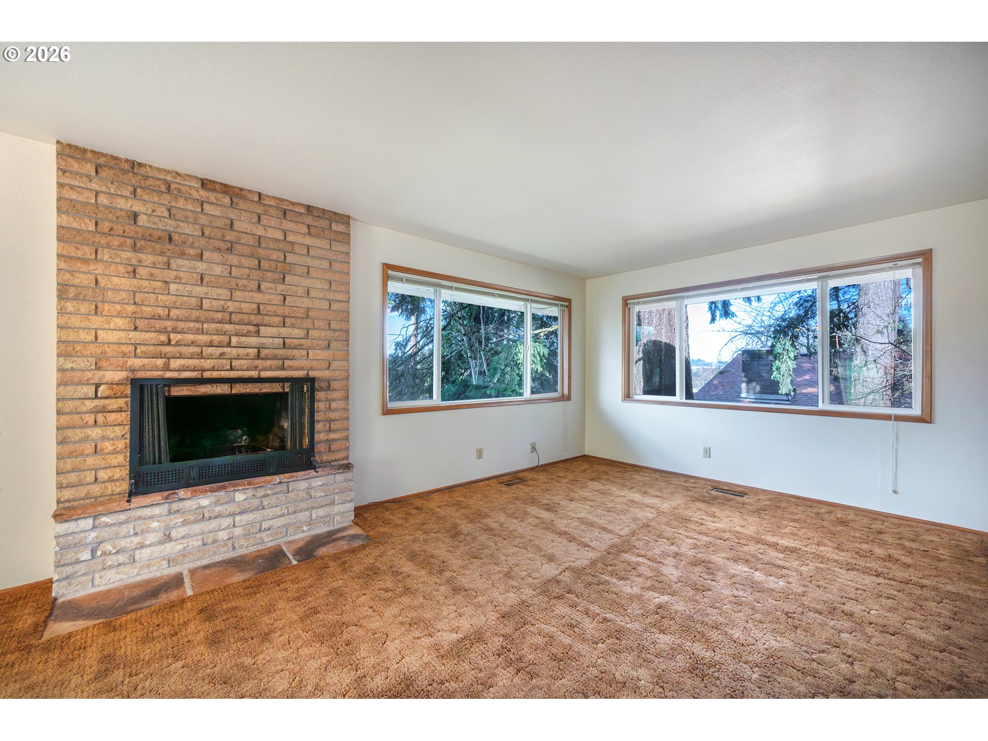 3392 Onyx Place Eugene, OR 97405 - Photo 22 of 41 a view of an empty room with a fireplace and wooden floor