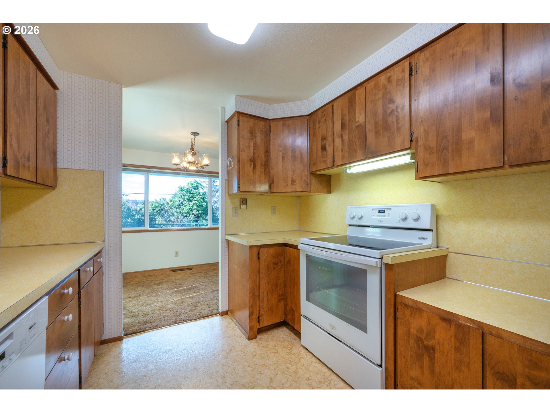 3392 Onyx Place Eugene, OR 97405 - Photo 8 of 41 a kitchen with stainless steel appliances granite countertop a stove a sink and a microwave