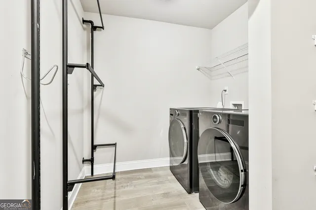 a spacious bedroom with a large bed and a chandelier