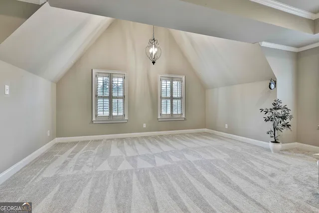 a spacious bedroom with a bed and a chandelier