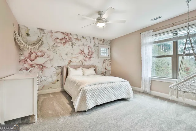 a spacious bedroom with a bed and a window