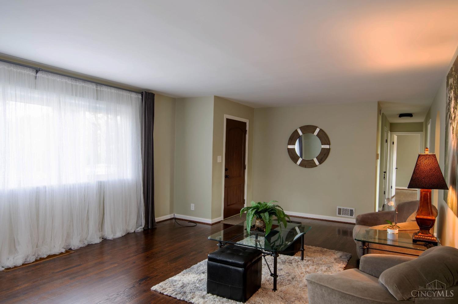 1385 Hunter Road Fairfield, OH 45014 - Photo 8 of 40 Large living room with gleaming hardwood floors and large picture windows offering abundant natural light.