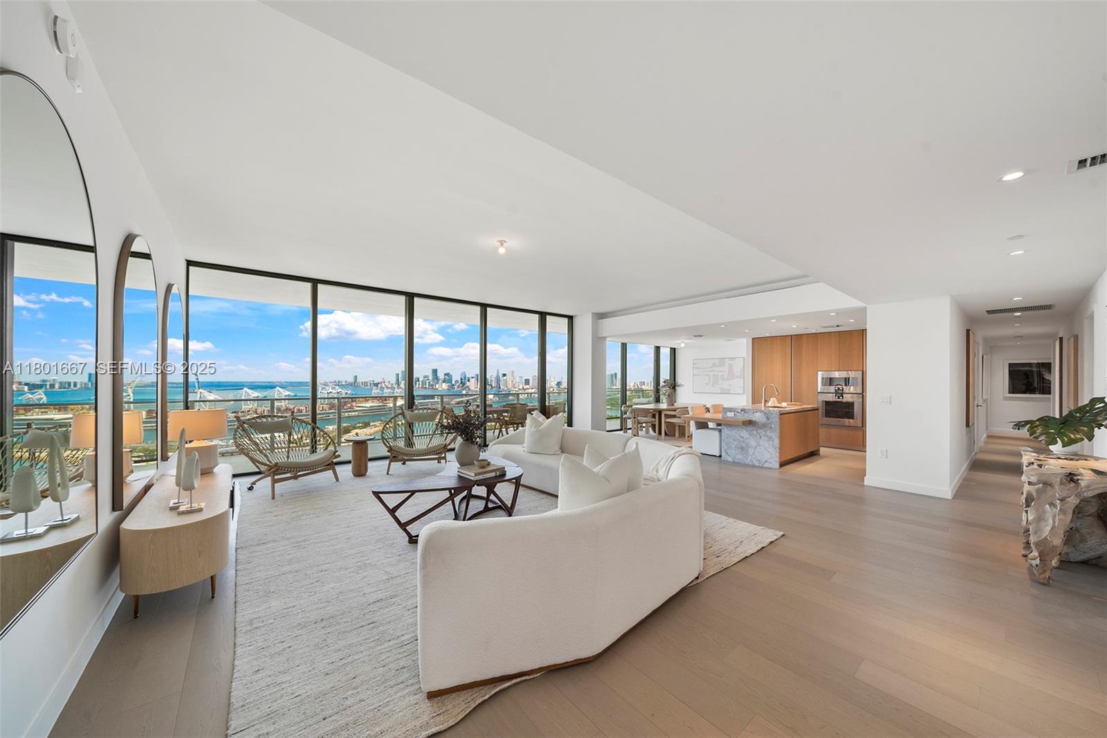 a living room with furniture and large windows