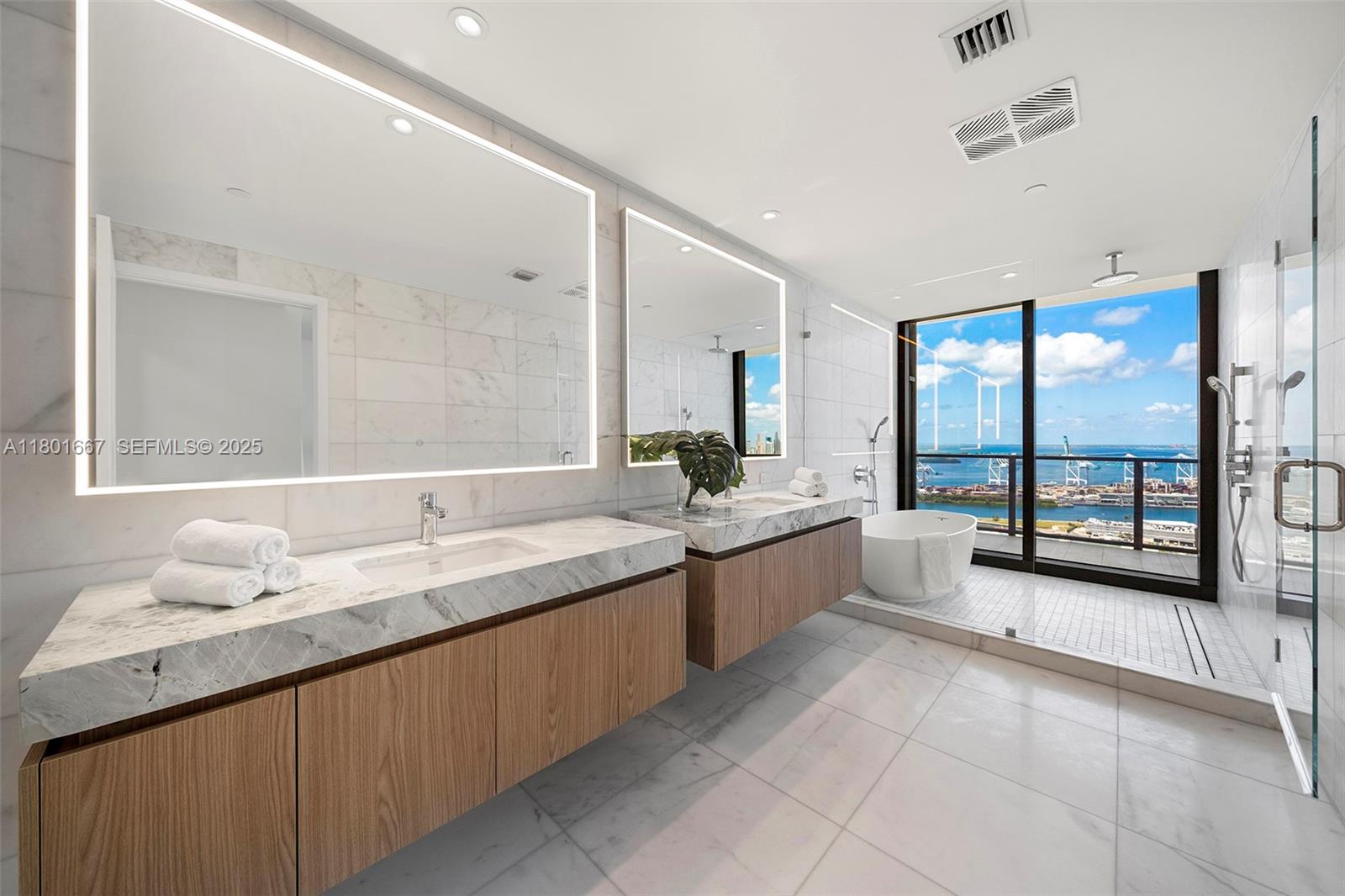 500 Alton Road, Unit 3602 Miami Beach, FL 33139 - Photo 15 of 33 a large bathroom with a large tub sink and mirror