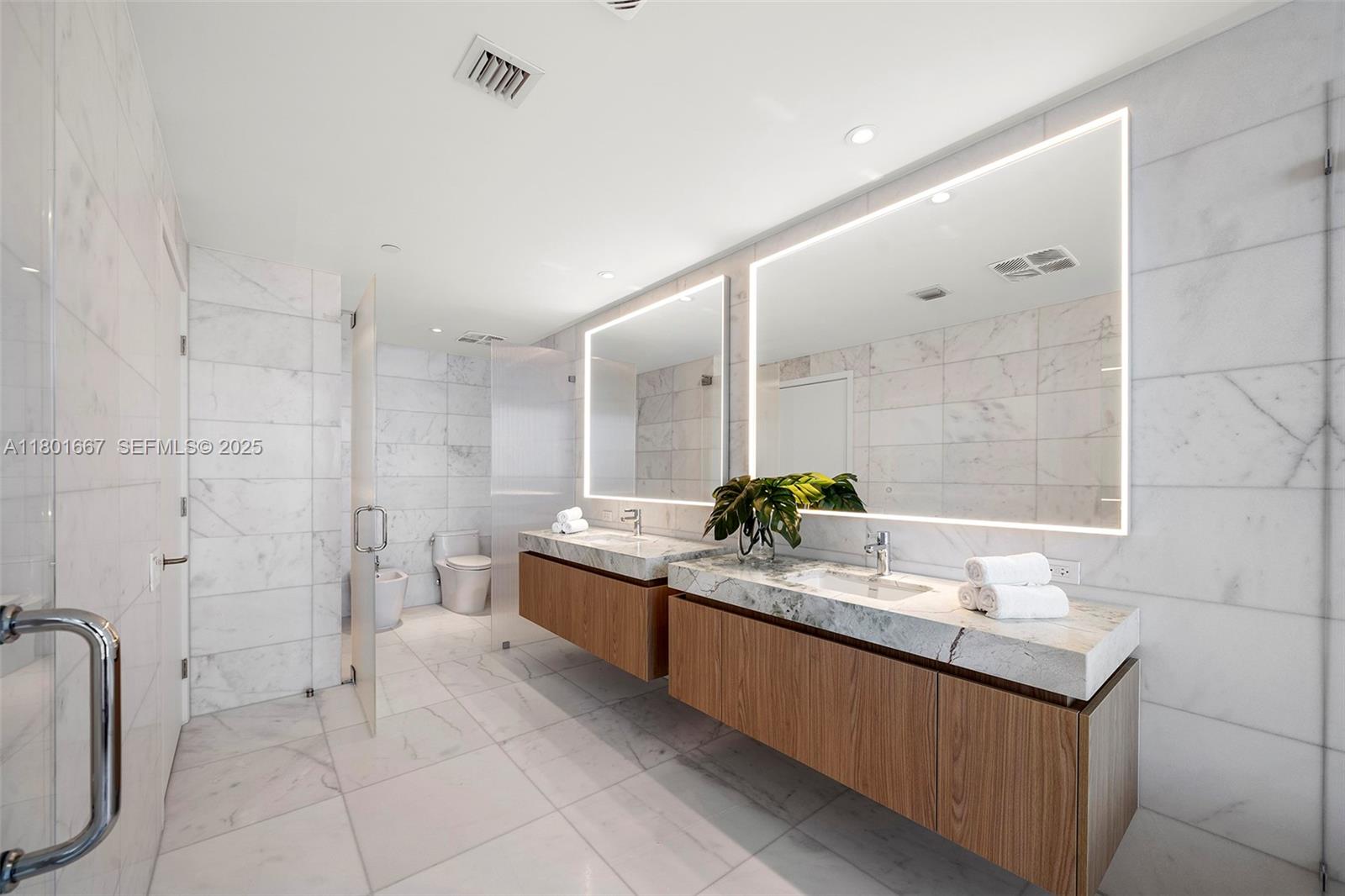 500 Alton Road, Unit 3602 Miami Beach, FL 33139 - Photo 16 of 33 a bathroom with a granite countertop sink mirror and a bathtub