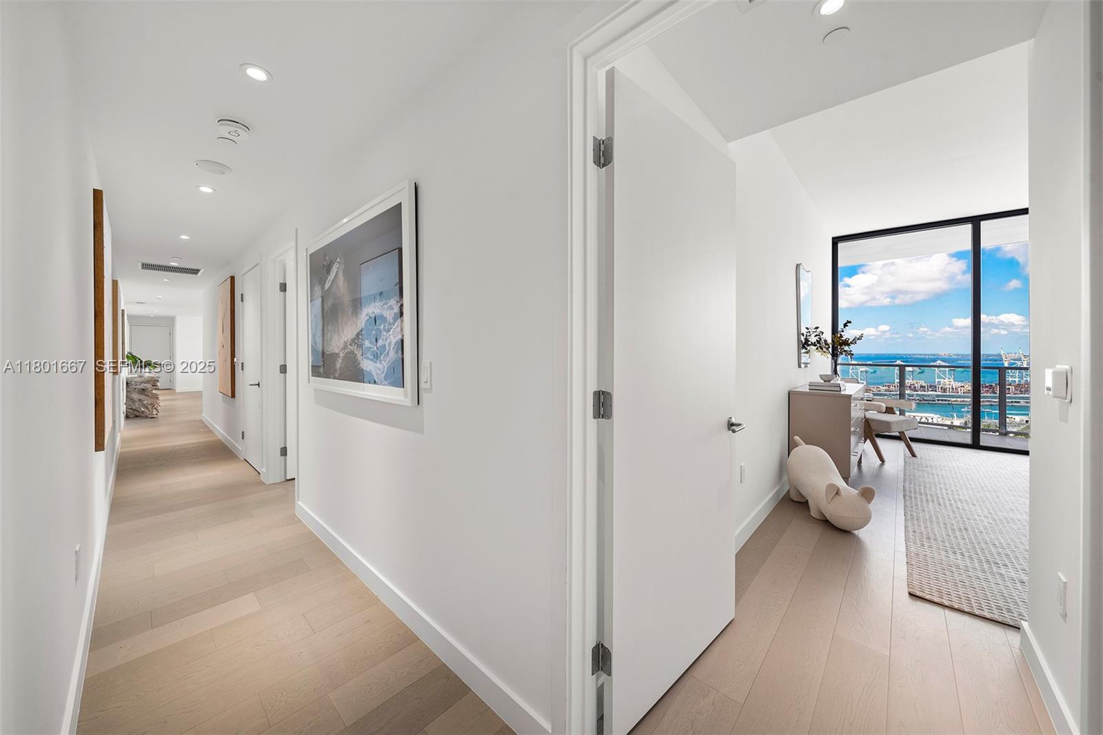 500 Alton Road, Unit 3602 Miami Beach, FL 33139 - Photo 18 of 33 a view of a hallway with couch and floor to ceiling window
