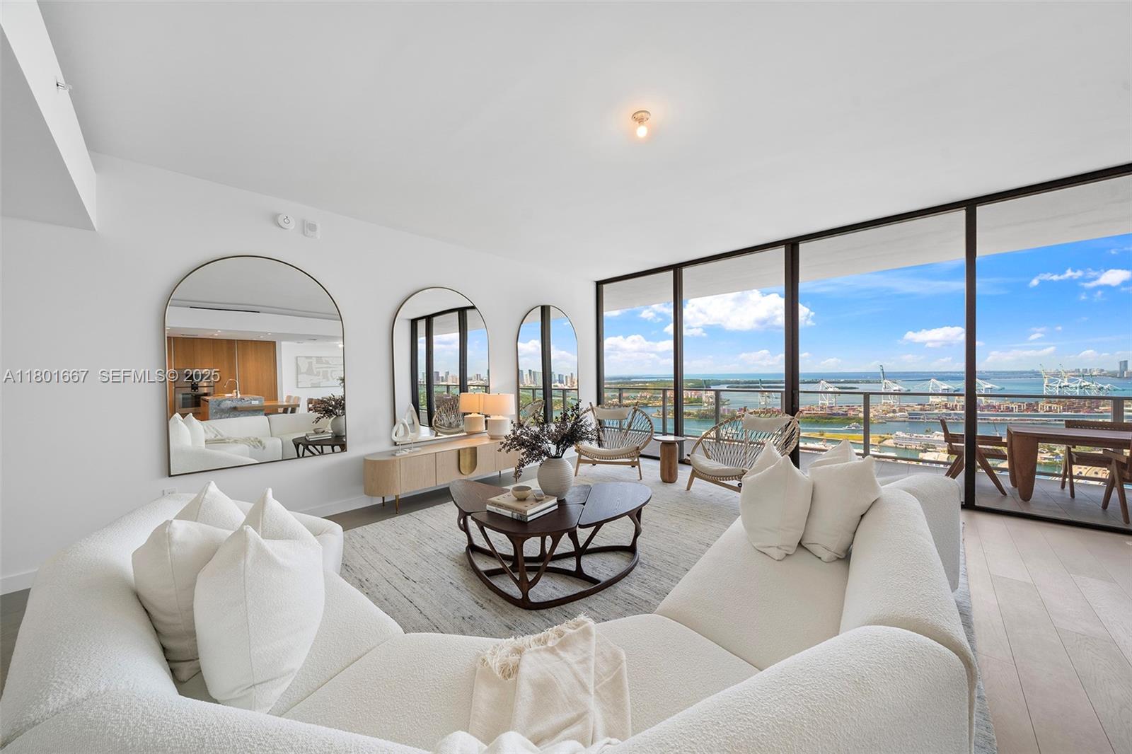 500 Alton Road, Unit 3602 Miami Beach, FL 33139 - Photo 2 of 33 a living room with furniture and floor to ceiling windows
