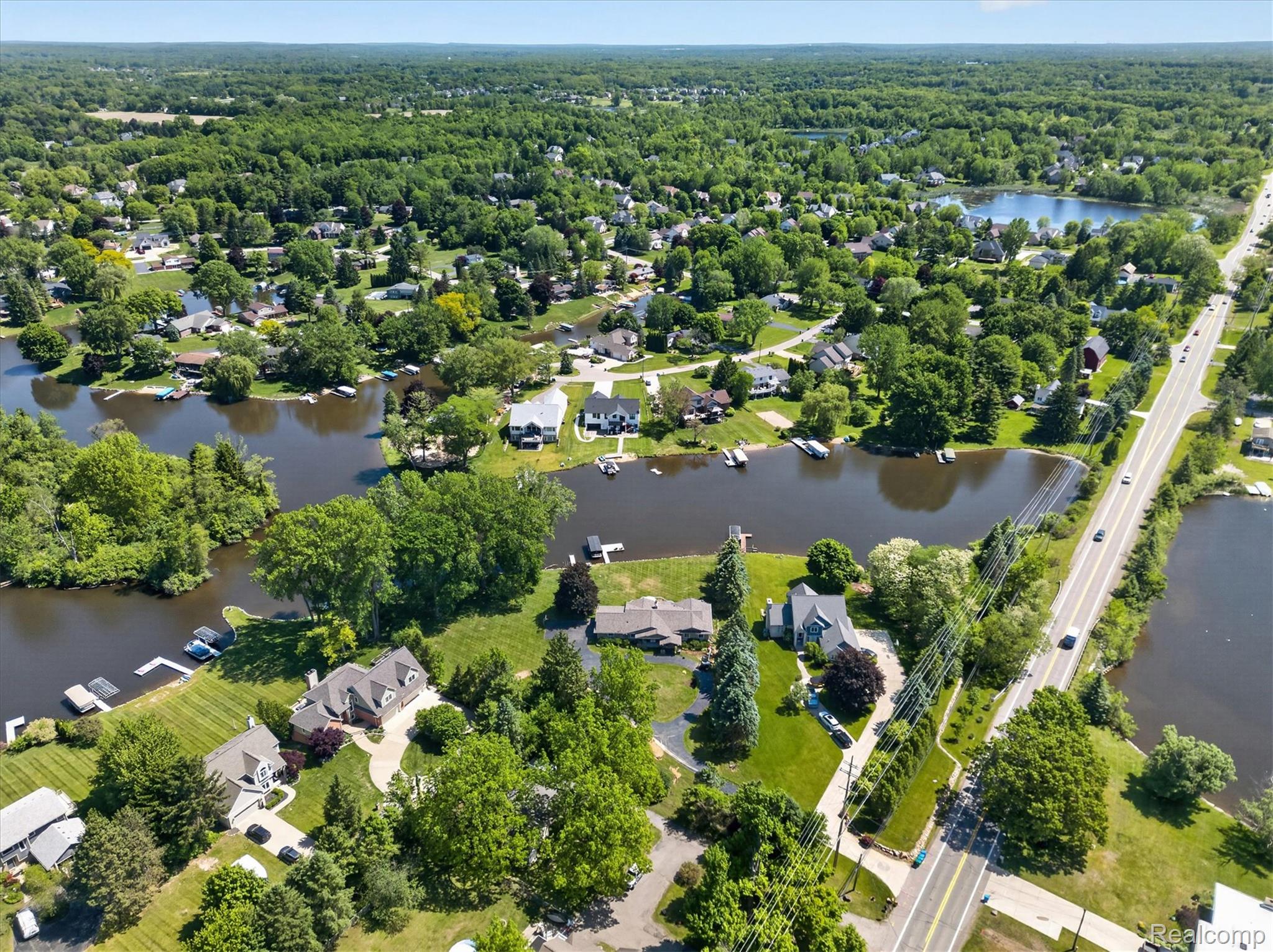 3860 East Commerce Road Commerce Township, MI 48382 - Photo 67 of 72 Aerial perspective showcasing a residential area with extensive waterways and lush green landscaping