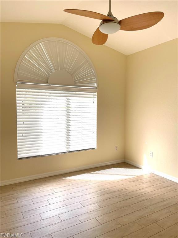 2132 Par Drive Naples, FL 34120 - Photo 11 of 17 Empty room featuring ceiling fan, light wood-type flooring, and lofted ceiling