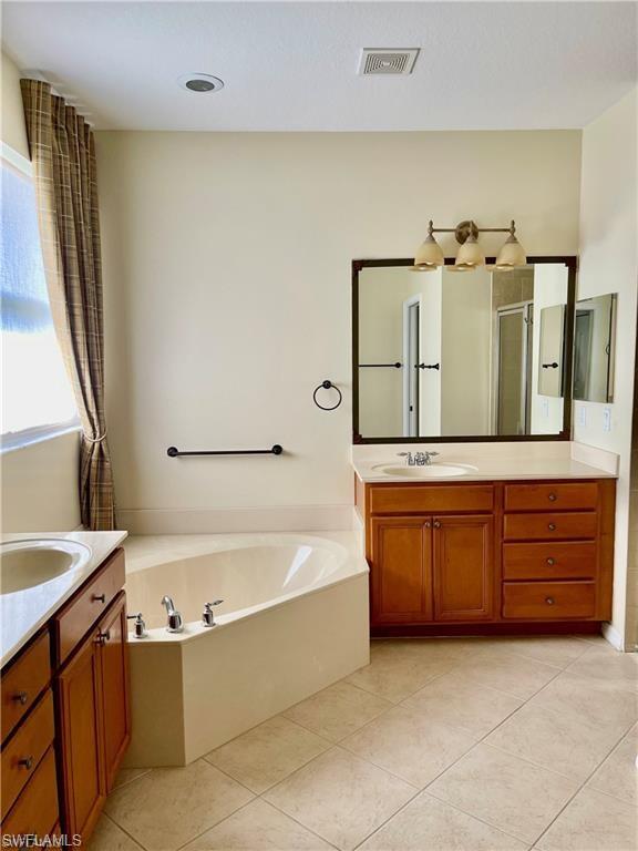 2132 Par Drive Naples, FL 34120 - Photo 7 of 15 a spacious bathroom with a tub sink and mirror