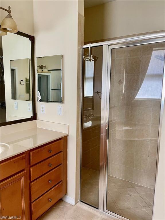 2132 Par Drive Naples, FL 34120 - Photo 8 of 15 a bathroom with a shower sink and mirror