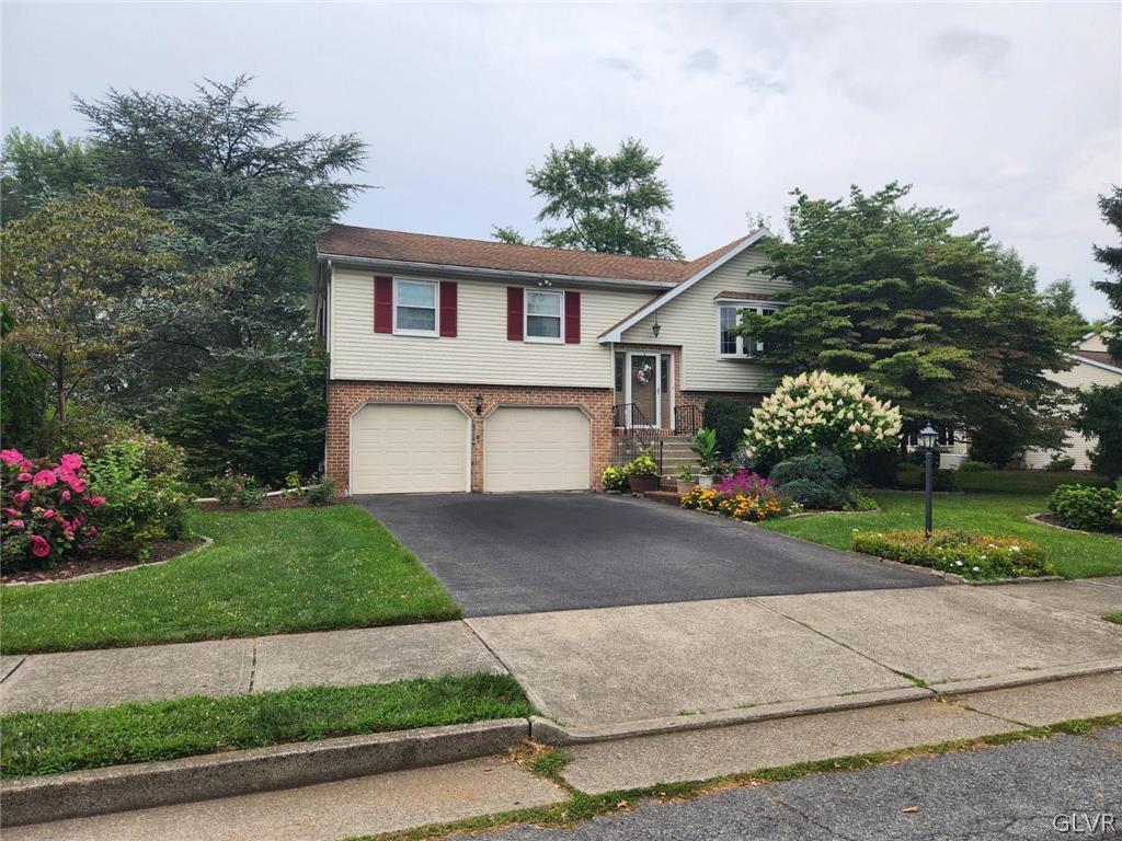 3055 Athena Drive Bethlehem, PA 18017 - Photo 1 of 6 a front view of house with garage and flowers