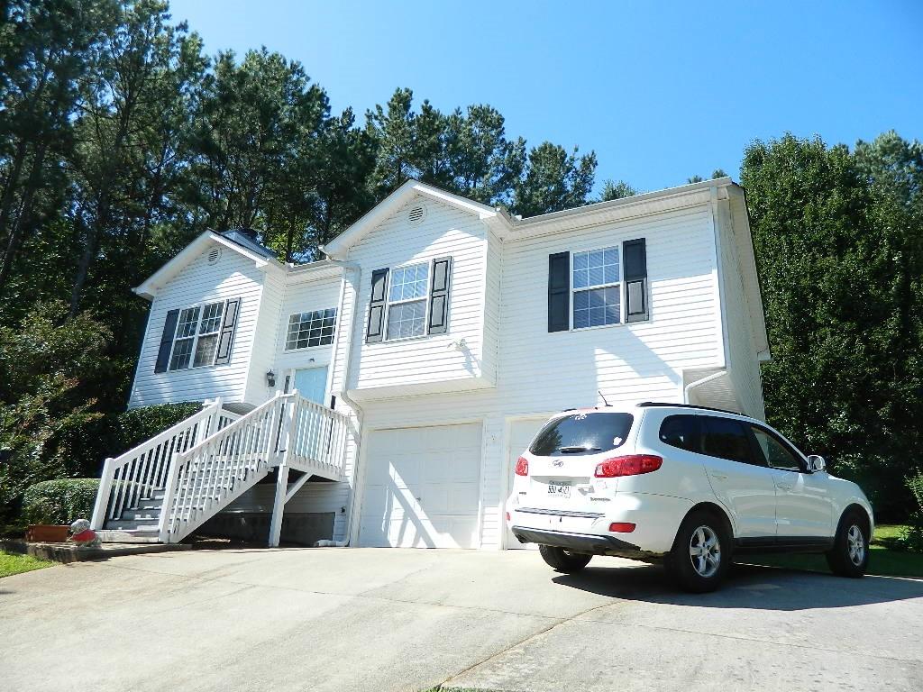 197 Lena Lane Dallas, GA 30132 - Photo 1 of 1 a white house covered with tall trees