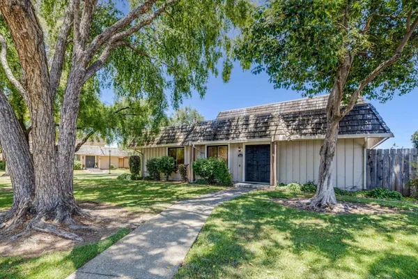 front view of a house with a tree in a yard