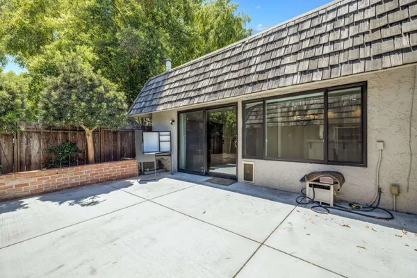 a view of a house with backyard porch and sitting area