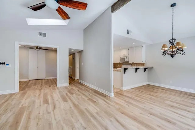 a view of a kitchen with wooden floor and a sink