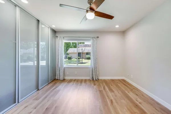 a view of room with window and wooden floor