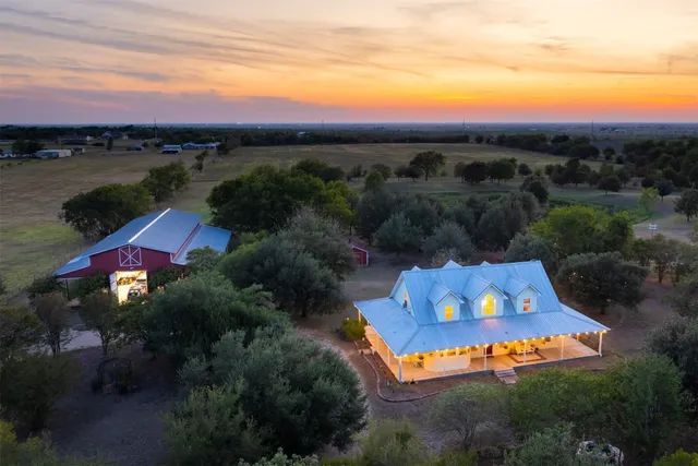 an aerial view of house with yard swimming pool and outdoor seating