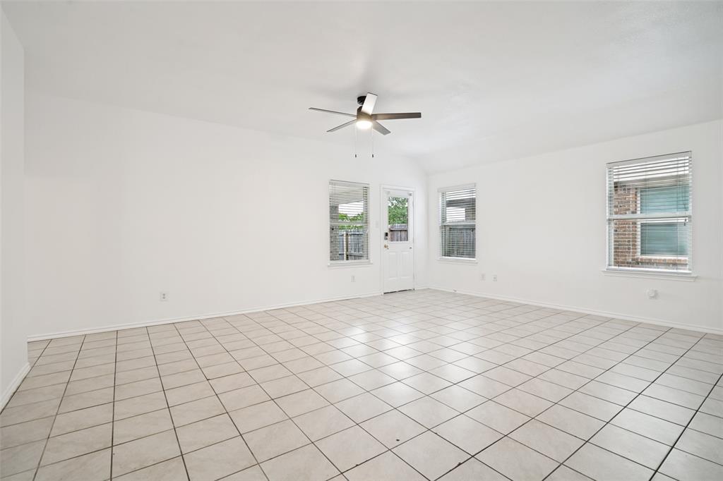 3415 Emerson Road Forney, TX 75126 - Photo 9 of 26 an empty room with windows and fan