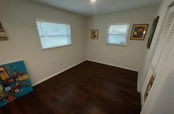 a view of room with hardwood floor and window