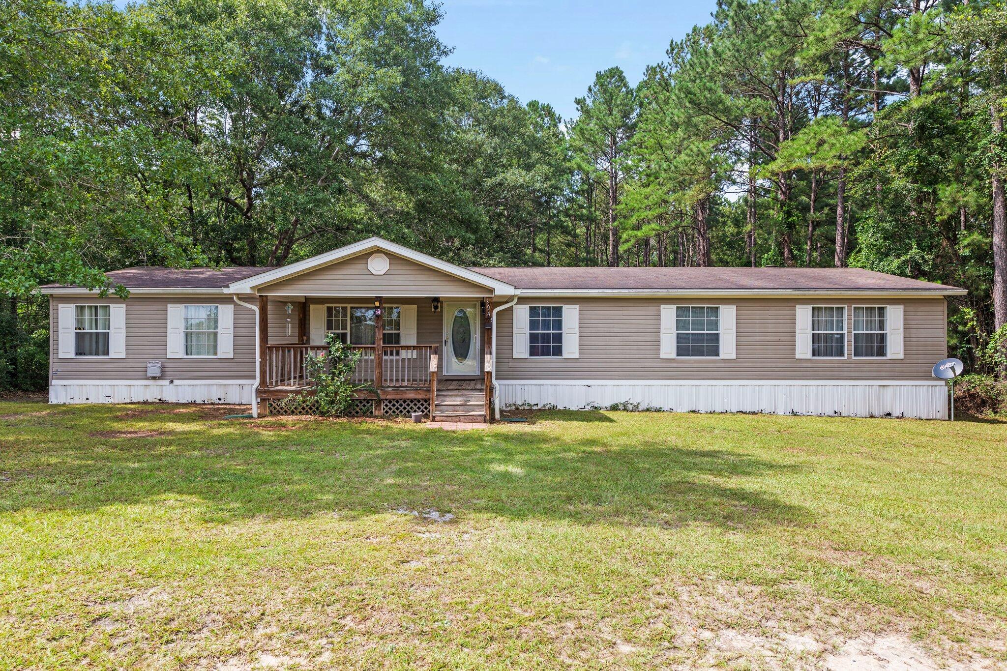 3943 Bambi Road Crestview, FL 32539 - Photo 1 of 36 a front view of a house with a garden