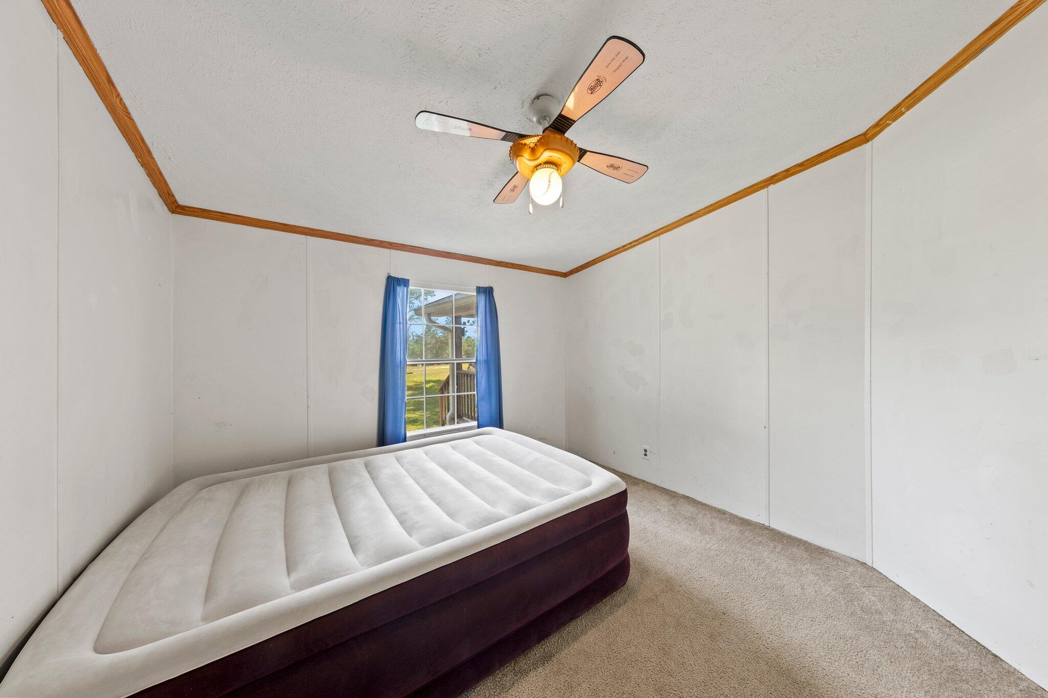 3943 Bambi Road Crestview, FL 32539 - Photo 23 of 36 a bedroom with a bed and a window
