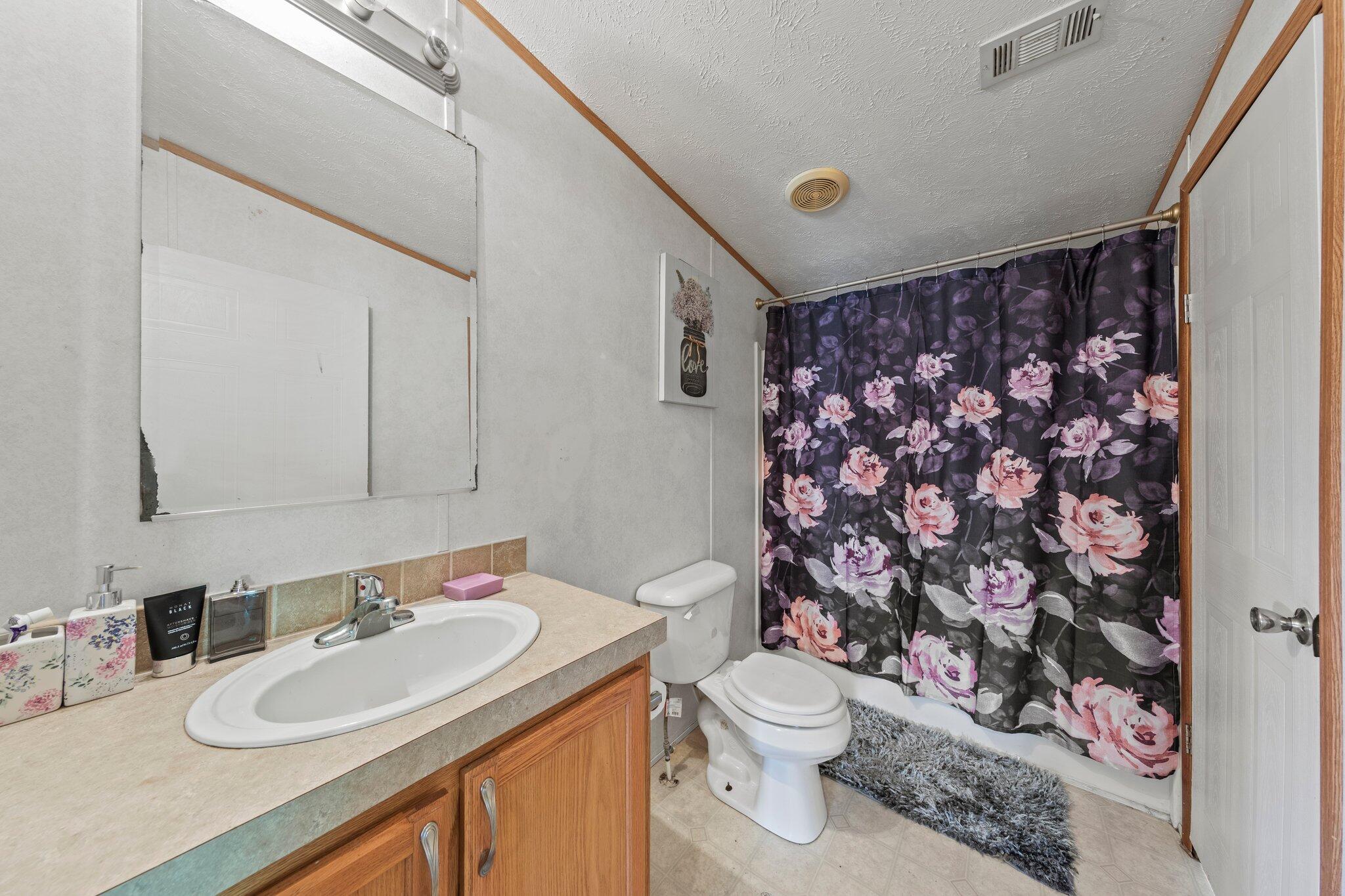 3943 Bambi Road Crestview, FL 32539 - Photo 26 of 36 a bathroom with a sink toilet vanity and shower